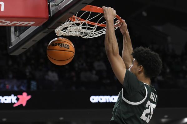 Michigan State's Malik Hall (25) dunks during the first half of an NCAA college basketball game against Northwestern, Sunday, Jan. 2, 2022, in Chicago. (AP Photo/Paul Beaty)