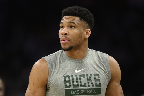 FILE - Milwaukee Bucks forward Giannis Antetokounmpo warms up for the team's NBA basketball game against the Washington Wizards, March 5, 2023, in Washington. Antetokounmpo, a minority owner of Nashville SC of the MLS, was on the field Saturday night, Aug. 19, 2023, before the start of his team's Leagues Cup final against Lionel Messi-led Inter Miami, playfully taking shots on goal. (AP Photo/Nick Wass, File)