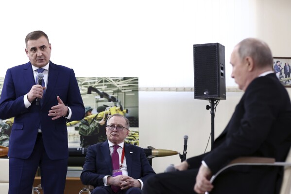 Russian President Vladimir Putin, right, listens to Tula Region Governor Alexey Dyumin, left, during a forum titled "All for a Victory!" held by the All-Russia People's Front in Tula, Russia, Friday, Feb. 2, 2024. (Artyom Geodakyan, Sputnik, Kremlin Pool Photo via AP)