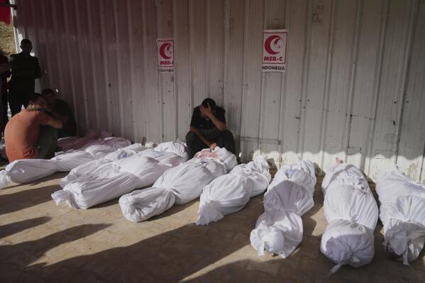 Palestinians mourn their relatives killed in an Israeli airstrikes in Jabalia, northern Gaza Strip, on Wednesday, May 14, 2025. According to local hospitals, 48 people were killed in the strikes, including 22 children. (AP Photo/Jehad Alshrafi)