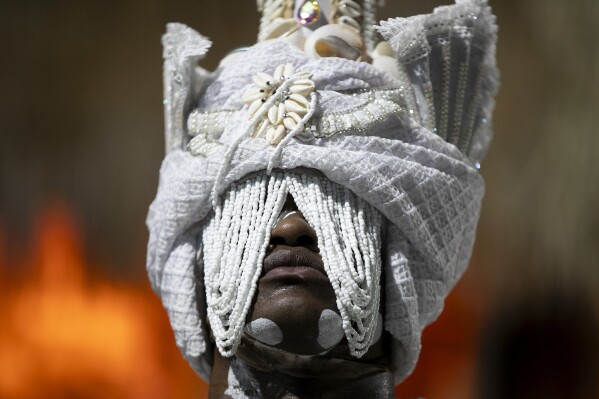 A performer from the Imperatriz Leopoldinense samba school parades on a float during Carnival celebrations at the Sambadrome in Rio de Janeiro, Monday, March 3, 2025. (AP Photo/Bruna Prado)