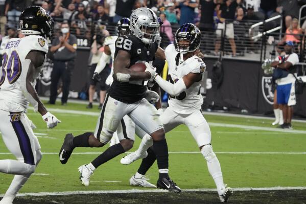 Las Vegas Raiders running back Josh Jacobs (28) scores a touchdown against the Baltimore Ravens during the second half of an NFL football game, Monday, Sept. 13, 2021, in Las Vegas. (AP Photo/Rick Scuteri)