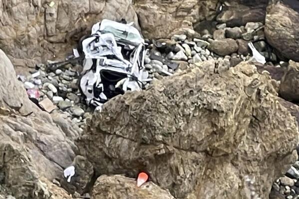 FILE - This image from video provided by San Mateo County Sheriff's Office shows a Tesla vehicle that plunged off a Northern California cliff along the Pacific Coast Highway, Monday, Jan. 2, 2023, near an area known as Devil's Slide, leaving four people in critical condition, a fire official said. The driver of the Tesla that plunged off a cliff in Northern California, seriously wounding two children and a second adult, intentionally caused the crash and has been arrested on suspicion of attempted murder and child abuse, the California Highway Patrol said Tuesday, Jan. 3, 2023. (San Mateo County Sheriff's Office via AP, File)