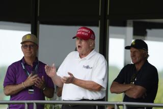 Former President Donald Trump, Greg Norman, LIV Golf CEO, right, and Paul Myler, deputy head of mission for the Australian Embassy in Washington, left, watch the second round of the LIV Golf at Trump National Golf Club, Saturday, May 27, 2023, in Sterling, Va. (AP Photo/Alex Brandon)