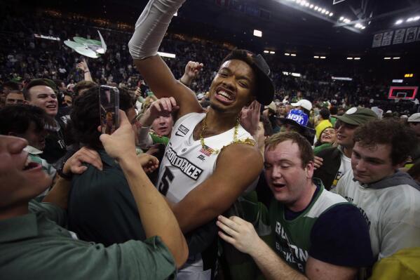 Providence's Ed Croswell (5) is surrounded by fans after an NCAA college basketball game against Creighton, Saturday, Feb. 26, 2022, in Providence, R.I. Providence won the regular season Big East title. (AP Photo/Stew Milne)