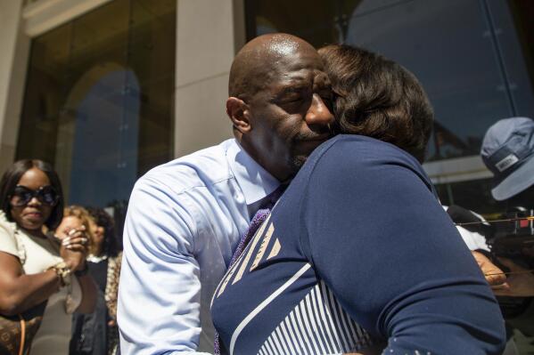 Former Tallahassee Mayor Andrew Gillum, left, and Sharon Lettman-Hicks embrace after he was found not guilty of lying to the FBI in a corruption case that also involved illegal use of campaign contributions, Thursday, May 4, 2023, in Tallahassee, Fla. The federal jury hung on charges of funneling tens of thousands of dollars in campaign money to personal accounts. (Alicia Devine/Tallahassee Democrat via AP)