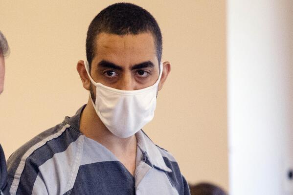 FILE — Hadi Matar listens during an arraignment in the Chautauqua County Courthouse in Mayville, NY., Aug. 18, 2022. The criminal case against Matar, the man charged with stabbing author Salman Rushdie, involves so much potential evidence that prosecutors need more time to review it, the chief prosecutor said Wednesday, Sept. 7, 2022. (AP Photo/Joshua Bessex, File)