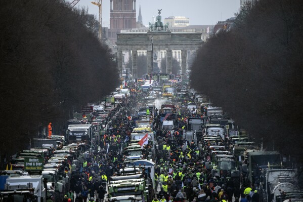 Farmers with tractors arrive for a protest at the Brandenburg Gate in Berlin, Germany, Jan. 15, 2024. This week began and ended with the long road in front of Berlin’s landmark Brandenburg Gate thronged by heavy vehicles tooting their horns in protest — farmers on Monday Jan. 15 and truckers on Friday Jan. 19, 2024. Such demonstrations underline deep frustration in Germany with Chancellor Olaf Scholz’s government, which came to power just over two years ago with a progressive, modernizing agenda but has come to be viewed by many as dysfunctional and incapable. (AP Photo/Ebrahim Noroozi, File)
