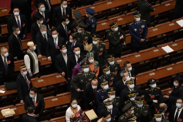Delegates leave after the opening ceremony for the National People's Congress held at the Great Hall of the People on March 5, 2022, in Beijing. Sustained, palpable anger in China over the case of a mother-of-eight found chained inside a shed has prompted an unusually strong government response to human trafficking at the annual session of China's rubber-stamp legislature. (AP Photo/Sam McNeil)