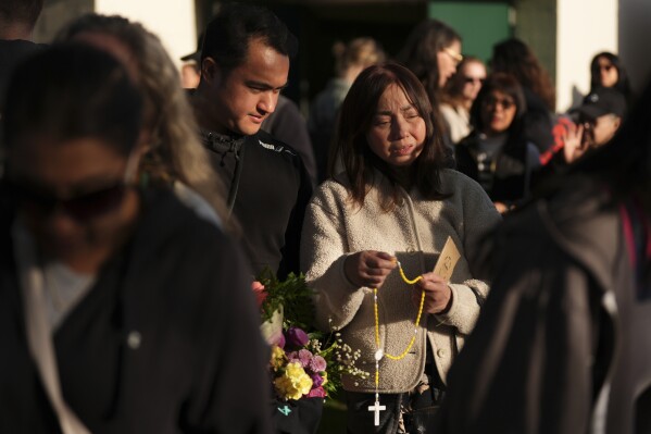 Gerard Gaba, left, and his mother Wilma Gaba, attend a vigil after a vehicle drove into a crowd during a Filipino heritage festival in Vancouver, British Columbia, Sunday, April 27, 2025. (AP Photo/Lindsey Wasson)