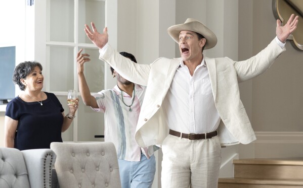 This image released by Amazon Prime shows John Cena, right, in a scene from "Ricky Stanicky." (Ben King/Amazon via AP)