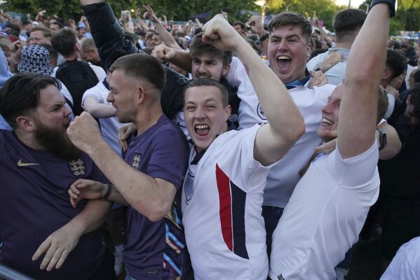 Fans celebrate England's first goal of the game, scored by Jude Bellingham, at the 4theFans Central Park in Brighton, England, Sunday, June 16, 2024 during a Group C match between Serbia and England at the Euro 2024 soccer tournament in Gelsenkirchen, Germany. (Gareth Fuller/PA via AP)