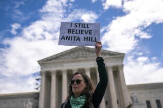 A protester holds a sign reading "I still believe Anita Hill" during a Planned Parenthood rally in support of abortion access outside the Supreme Court on Saturday, April. 15, 2023, in Washington. (AP Photo/Nathan Howard)