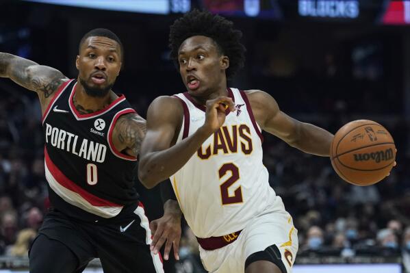 FILE - Cleveland Cavaliers' Collin Sexton (2) drives against Portland Trail Blazers' Damian Lillard (0) in the first half of an NBA basketball game, Wednesday, Nov. 3, 2021, in Cleveland. The Cavaliers made the expected move Tuesday, June 28, 2022, and extended a qualifying offer to guard Collin Sexton, who missed most of last season with a knee injury.(AP Photo/Tony Dejak, File)