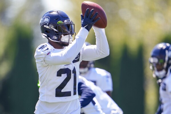 Seattle Seahawks cornerback Devon Witherspoon catches a ball during warmup drills at the NFL football team's training camp Thursday, Aug. 3, 2023, in Renton, Wash. (AP Photo/Lindsey Wasson)