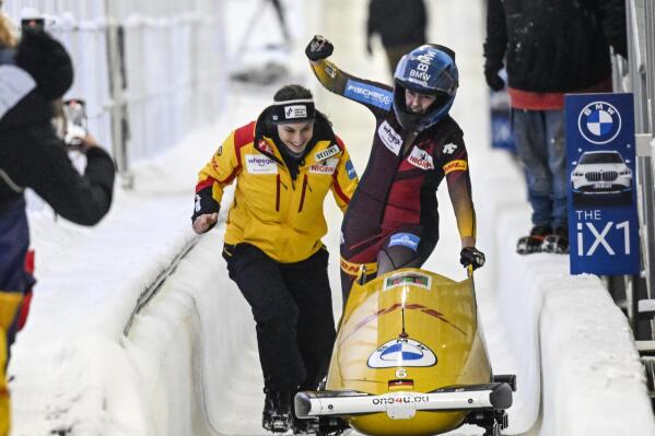 Laura Nolte, , right, of Germany, celebrates a first-place finish after the second run of the women's monobob World Cup race on Saturday, Dec. 17, 2022, in Lake Placid, N.Y. (AP Photo/Hans Pennink)