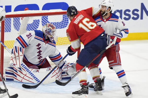 Florida Panthers center Aleksander Barkov (16) scores against New York Rangers goaltender Igor Shesterkin (31) in the third period of Game 3 during the Eastern Conference finals of the NHL hockey Stanley Cup playoffs, Sunday, May 26, 2024, in Sunrise, Fla. (AP Photo/Wilfredo Lee)