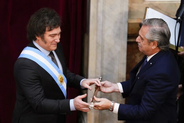 Incoming Argentine President Javier Miley receives the presidential baton from outgoing President Alberto Fernandez at Congress in Buenos Aires, Argentina, Sunday, December 10, 2023. (AP Photo/Natasha Pisarenko)
