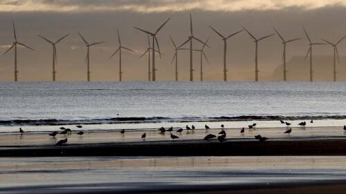 FILE - An offshore wind farm is visible from the beach in Hartlepool, England, Tuesday, Nov. 12, 2019. The U.K. government's climate advisers on Wednesday slammed officials for their slow pace of action in meeting their “net zero” greenhouse gas emissions target and backtracking on fossil fuel commitments, saying Britain has “lost its clear global leadership position on climate action." (AP Photo/Frank Augstein, File)