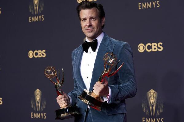 FILE - Jason Sudeikis appears with his awards for outstanding lead actor in a comedy series and best comedy series for "Ted Lasso" at the 73rd Primetime Emmy Awards in Los Angeles on Sept. 19, 2021.  Sudeikis returned to his hometown of Kansas City to host Thundergong!, a benefit concert to raise money for Steps of Faith Foundation. The organization helps amputees who lack proper health coverage pay for prosthetic limbs. The concert will stream worldwide on Nov. 20 at 7 p.m. CST at Thundergong.org. (AP Photo/Chris Pizzello, File)