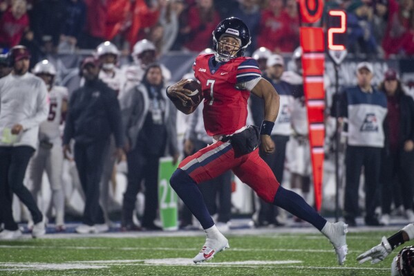 Liberty's Kaidon Salter runs for a touchdown against New Mexico State during the second half of the Conference USA championship NCAA college football game Friday, Dec. 1, 2023, in Lynchburg, Va. (AP Photo/Robert Simmons)