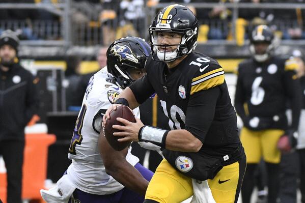 Pittsburgh Steelers quarterback Mitch Trubisky looks to pass under pressure from Baltimore Ravens linebacker Tyus Bowser during the second half of an NFL football game in Pittsburgh, Sunday, Dec. 11, 2022. (AP Photo/Don Wright)