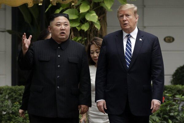 FILE - In this Feb. 28, 2019, file photo, U.S. President Donald Trump and North Korean leader Kim Jong Un take a walk after their first meeting at the Sofitel Legend Metropole Hanoi hotel, in Hanoi, Vietnam. South Korea's president Moon Jae-in on Tuesday, June 25, 2019, said North Korean and U.S. officials are holding "behind-the-scenes talks" to set up a third summit between the countries' leaders. (AP Photo/Evan Vucci, File)