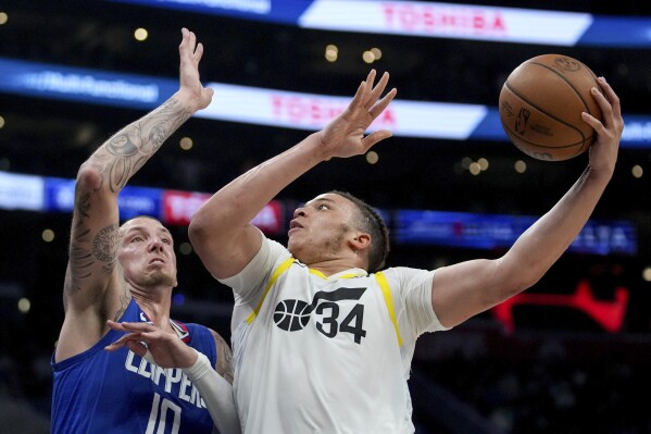 Utah Jazz forward Kenneth Lofton Jr. (34) goes to the basket against Los Angeles Clippers center Daniel Theis (10) during the second half of an NBA basketball game in Los Angeles, Friday, April 12, 2024. (AP Photo/Eric Thayer)