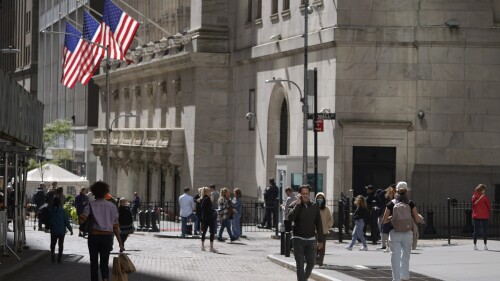 FILE - Visitors to the financial district walk past the New York Stock Exchange, Friday, Sept. 23, 2022, in New York. (AP Photo/Mary Altaffer, File)