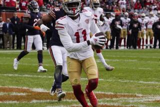 FILE - San Francisco 49ers wide receiver Brandon Aiyuk scores a touchdown against the Chicago Bears during the second half of an NFL football game Sunday, Oct. 31, 2021, in Chicago. After being a no-show offensively early in the season, Aiyuk is coming off his best game of the year this past week at Chicago with four catches for 45 yards, a 21-yard punt return that set up a TD and a key downfield block on a 39-yard run by Elijah Mitchell that helped seal the game. (AP Photo/Nam Y. Huh, File)