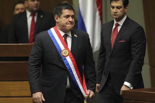 FILE - Paraguay's outgoing President Horacio Cartes arrives in Congress to pass on the presidential sash and baton to the incoming president, in Asuncion, Paraguay, Aug. 15, 2018. Paraguay’s attorney general launched a criminal investigation Thursday, March 23, 2023, into U.S. allegations that Cartes and the current vice president were involved in corruption and had ties to a terrorist group. (AP Photo/Marta Escurra, File)