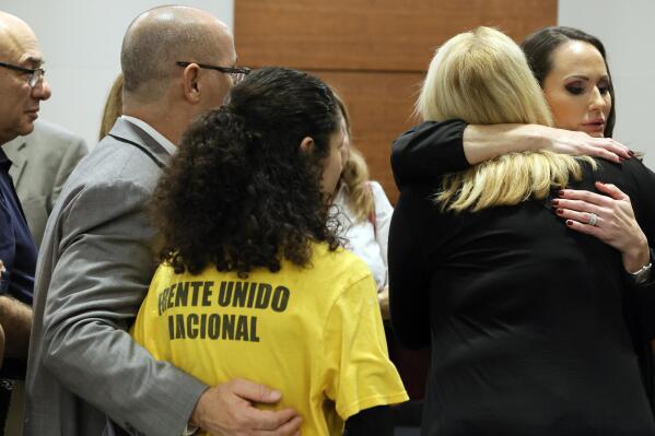 FILE - Judge Elizabeth Scherer hugs Jennifer Guttenberg following the sentencing hearing for Parkland school shooter Nikolas Cruz at the Broward County Courthouse in Fort Lauderdale, Fla., on Nov. 2, 2022. Guttenberg's daughter, Jaime, was killed in the 2018 shootings. Scherer was removed from another death penalty murder case Thursday, April 13, 2023, by the Florida Supreme Court, which agreed she showed unfair sympathy for prosecutors in the Parkland case. (Amy Beth Bennett/South Florida Sun Sentinel via AP, Pool, File)