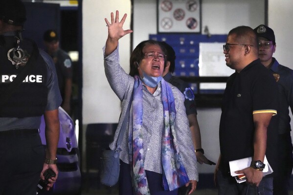 Former senator Leila de Lima, center, waves after she is released from the police custodial center at Camp Crame in Quezon City, Philippines on Nov. 13, 2023. A Philippine court on Monday ordered the temporary release on bail of the country's most popular prisoner, who was jailed as a senator more than six years ago on drug charges she said were fabricated to muzzle her investigation of then-President Rodrigo Duterte's brutal anti-drugs crackdown. (AP Photo/Aaron Favila)