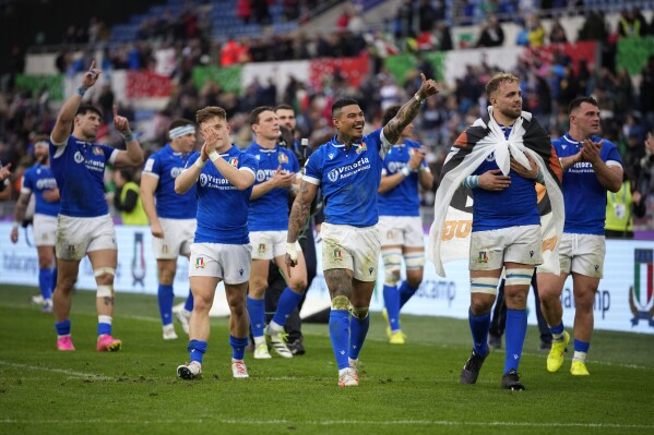 Italy's players celebrate at the end of the Six Nations rugby union international match between Italy and Scotland, at Rome's Olympic Stadium, Saturday, March 9, 2024. Italy beat Scotland by 31-29. (AP Photo/Andrew Medichini)