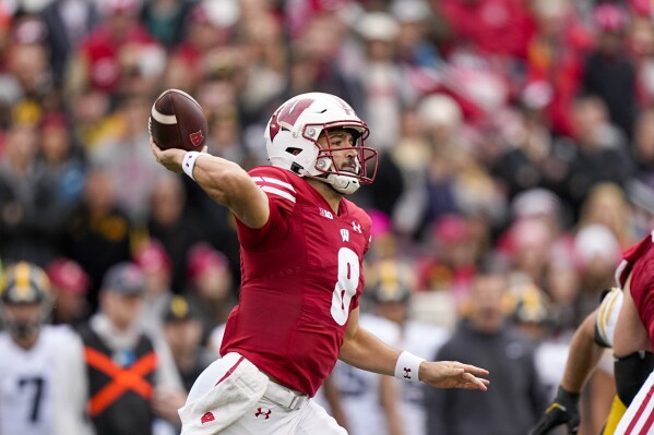 Wisconsin quarterback Tanner Mordecai (8) throws against Iowa during the first half of an NCAA college football game Saturday, Oct. 14, 2023, in Madison, Wis. (AP Photo/Andy Manis)