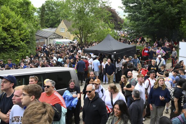 People queue for entry to the traditional annual Cheese Rolling contest at Cooper's Hill in Brockworth, Gloucestershire, England, Monday, May 26, 2025.(AP Photo/Anthony Upton)