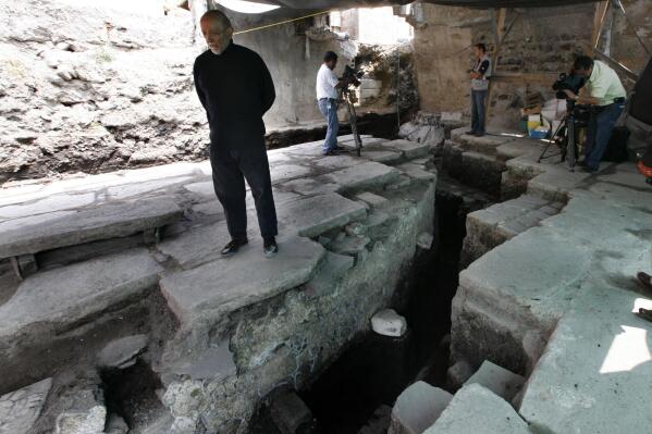 FILE - Archaeologist Eduardo Matos Moctezuma stands over a newly discovered platform at the archaeological site of Templo Mayor in Mexico City, Mexico, Oct. 6, 2011. Eduardo Matos Moctezuma, a celebrated Mexican archaeologist who led the excavation of the Great Aztec Temple in Mexico City, won this year’s Princess of Asturias award in the social sciences category, the Spanish foundation behind the prizes announced Wednesday May 18, 2022. (AP Photo/Marco Ugarte, File)