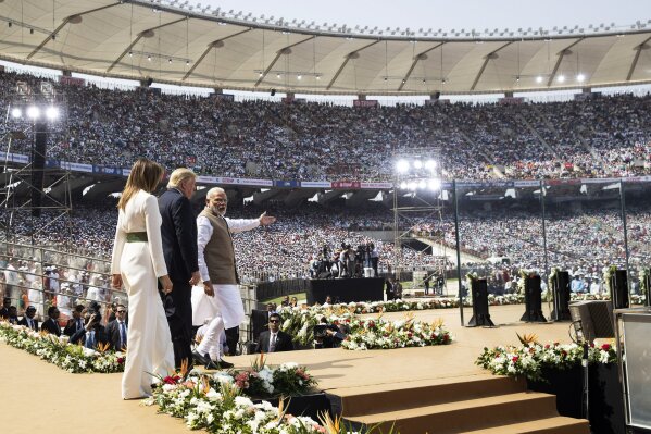 U.S. President Donald Trump, first lady Melania Trump, and Indian Prime Minister Narendra Modi arrive for a "Namaste Trump," event at Sardar Patel Stadium, Monday, Feb. 24, 2020, in Ahmedabad, India. After Air Force One touched down in Ahmedabad in western India, Trump's motorcade slowly drove down streets lined with hundreds of thousands of onlookers. He began that day's high-wattage trio of presidential photo-ops: a visit to a former home of independence leader Mohandas Gandhi, a rally at a huge cricket stadium and a trip to the famed Taj Mahal. (AP Photo/Alex Brandon)