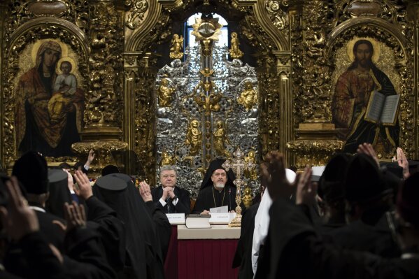 
              Ukrainian President Petro Poroshenko, center left, attends a closed-door synod of three Ukrainian Orthodox churches to approve the charter for a unified church and to elect leadership in the St. Sophia Cathedral in Kiev, Ukraine, Saturday, Dec. 15, 2018. Poroshenko has told the crowd "the creation of our Church is another declaration of Ukraine's independence and you are the main participants of this historic event." (Mikhail Palinchak, Ukrainian Presidential Press Service/Pool Photo via AP)
            