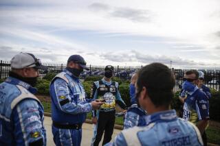 Kevin Harvick, third from left, celebrates with members of his crew after winning a NASCAR Cup Series auto race at Atlanta Motor Speedway, Sunday, June 7, 2020, in Hampton, Ga. (AP Photo/Brynn Anderson)