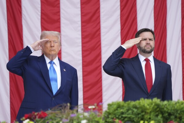 President Donald Trump and Vice President JD Vance salute during the 157th National Memorial Day Observance at Arlington National Cemetery, Monday, May 26, 2025, in Arlington, Va. (AP Photo/Jacquelyn Martin)