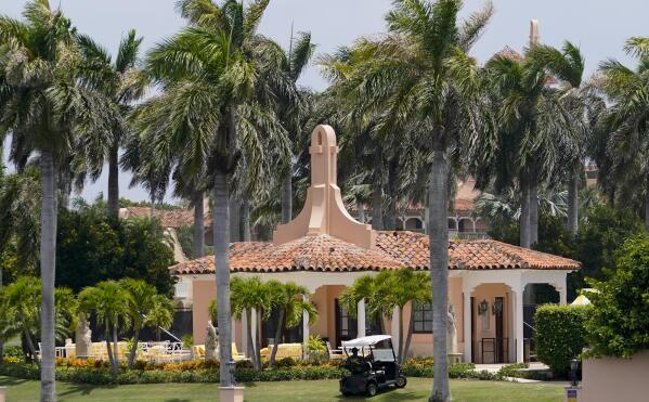 Security moves in a golf cart at former President Donald Trump's Mar-a-Lago estate, Tuesday, Aug. 9, 2022, in Palm Beach, Fla. The FBI searched Trump's Mar-a-Lago estate as part of an investigation into whether he took classified records from the White House to his Florida residence, people familiar with the matter said Monday. (AP Photo/Lynne Sladky)