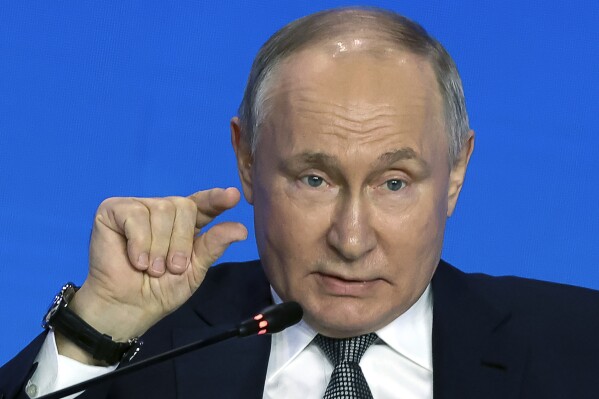 Russian President Vladimir Putin gestures as he speaks to scientists on the sidelines of the Future Technologies Forum at the World Trade Centre in Moscow, Russia, Wednesday, Feb. 14, 2024. (Sergei Karpukhin, Sputnik, Kremlin Pool Photo via AP)