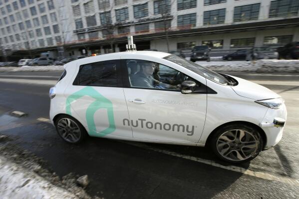 In this Tuesday, Jan. 10, 2017, photo, an autonomous vehicle is driven by an engineer on a street through an industrial park, in Boston. Researchers at Massachusetts Institute of Technology are asking human drivers how they'd handle life-or-death decisions in hopes of creating better algorithms to guide autonomous vehicles. (AP Photo/Steven Senne)