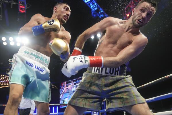 Teofimo Lopez, left, punches Scotland's Josh Taylor during the eighth round of a welterweight title bout, Saturday, June 10, 2023 in New York. Lopez won the fight. (AP Photo/Frank Franklin II)