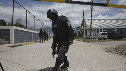 Military police guard the entrance to the National Penitentiary Center in Tamara, on the outskirts of Tegucigalpa, Honduras, Tuesday, June 26, 2023. Honduran President Xiomara Castro has put the military police in charge of the country's poorly-run prisons as the Central American country adopts El Salvador-style tactics in an anti-gang crackdown on prison inmates. (AP Photo/Elmer Martinez)