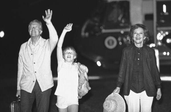 FILE - President Jimmy Carter, daughter Amy and first lady Rosalynn Carter wave to a group of people waiting on the Truman balcony of the White House in Washington, July 2, 1979 as the Carters arrive after their trip to Tokyo and South Korea. Rosalynn Carter turns 96 on Friday, Aug. 18, 2023 and is celebrating at home in Plains, Ga., with her family, including former President Jimmy Carter. Her plan includes eating cupcakes and peanut butter ice cream, then releasing butterflies in her garden -- with friends doing the same around the Carters' hometown. (AP Photo, file)