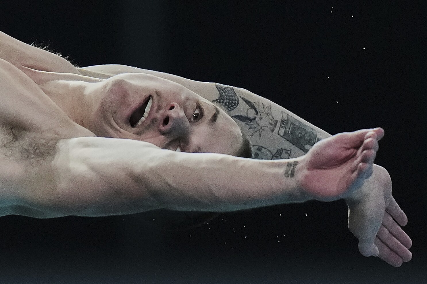 AP PHOTOS: Expressions of divers in the split second between diving board and the water