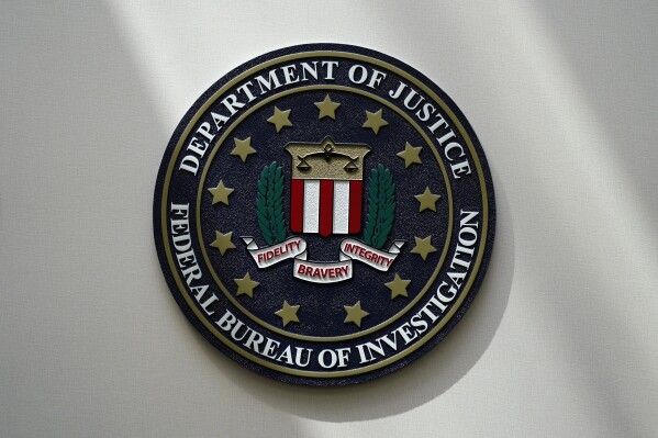 FILE - An FBI seal is seen on a wall on Aug. 10, 2022, in Omaha, Neb. Data in the FBI's annual crime report released Monday, Oct. 16, 2023 shows that violent crime across the U.S. decreased last year, dropping to about the same level as before the onset of the COVID-19 pandemic. (AP Photo/Charlie Neibergall, File)