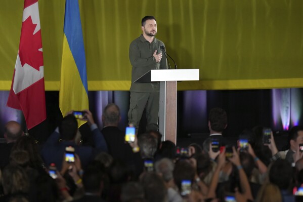 FILE - Ukrainian President Volodymyr Zelenskyy listens to an impromptu rendition of the Ukrainian national anthem at an event including members of the Ukrainian-Canadian community, in Toronto, on Friday, Sept. 22, 2023. Ukrainian President Volodymyr Zelenskyy was traveling home from North America, where he addressed the U.N. General Assembly and paid his first wartime visit to Canada.(Chris Young/The Canadian Press via AP)